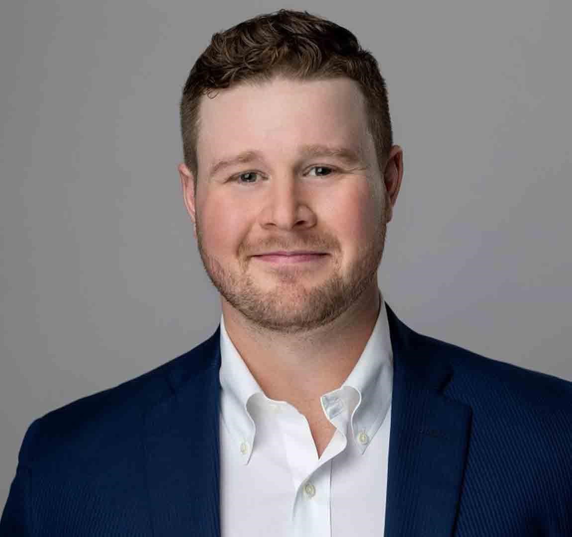Matthew_McCaffer seen in a white color shirt and dark blue color suit